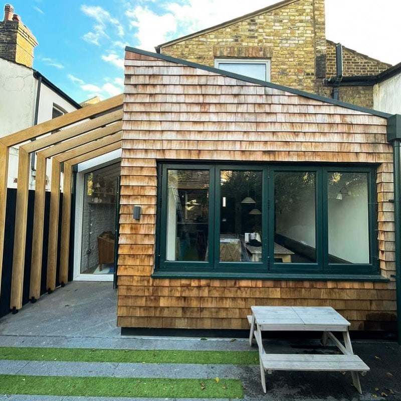 Timber-shingle clad rear extension with a pergola at Hansler Road