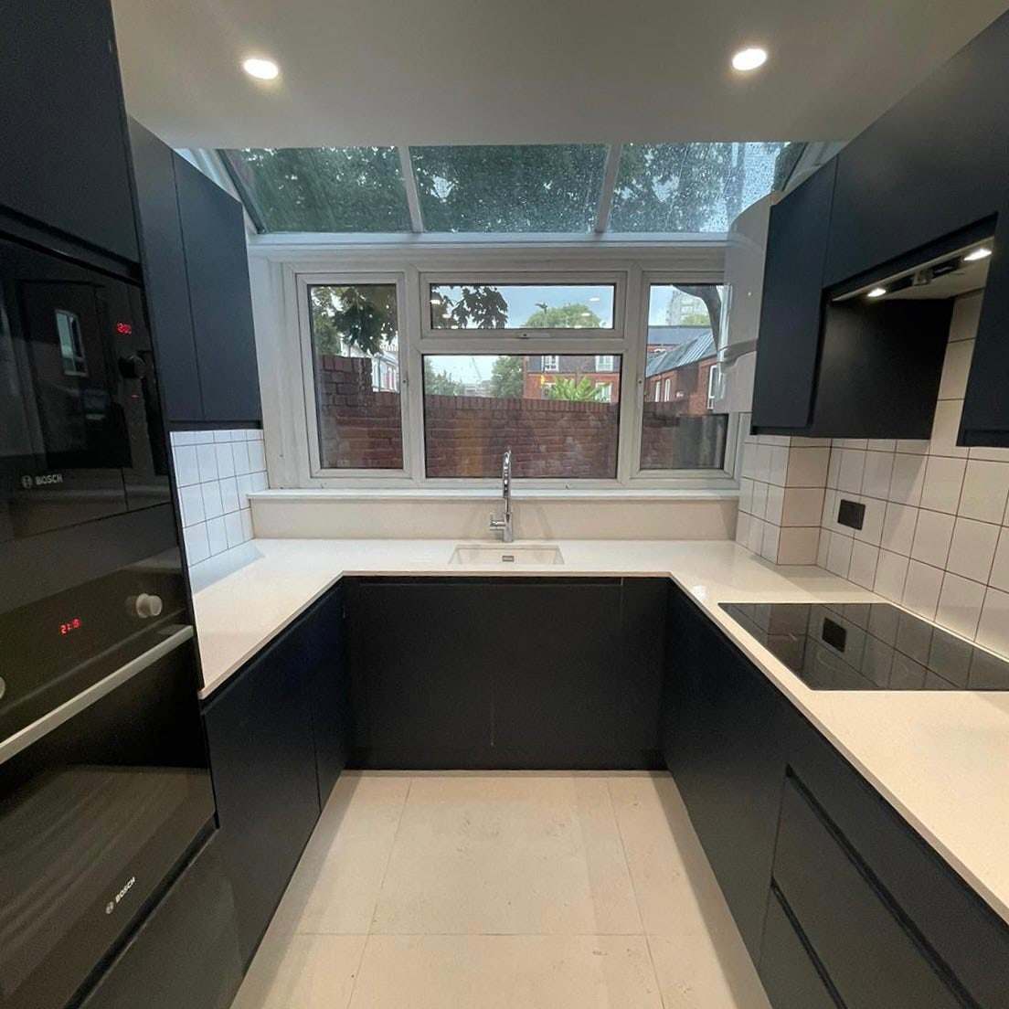 New black kitchen with a solid quartz worktop at Rigge Place